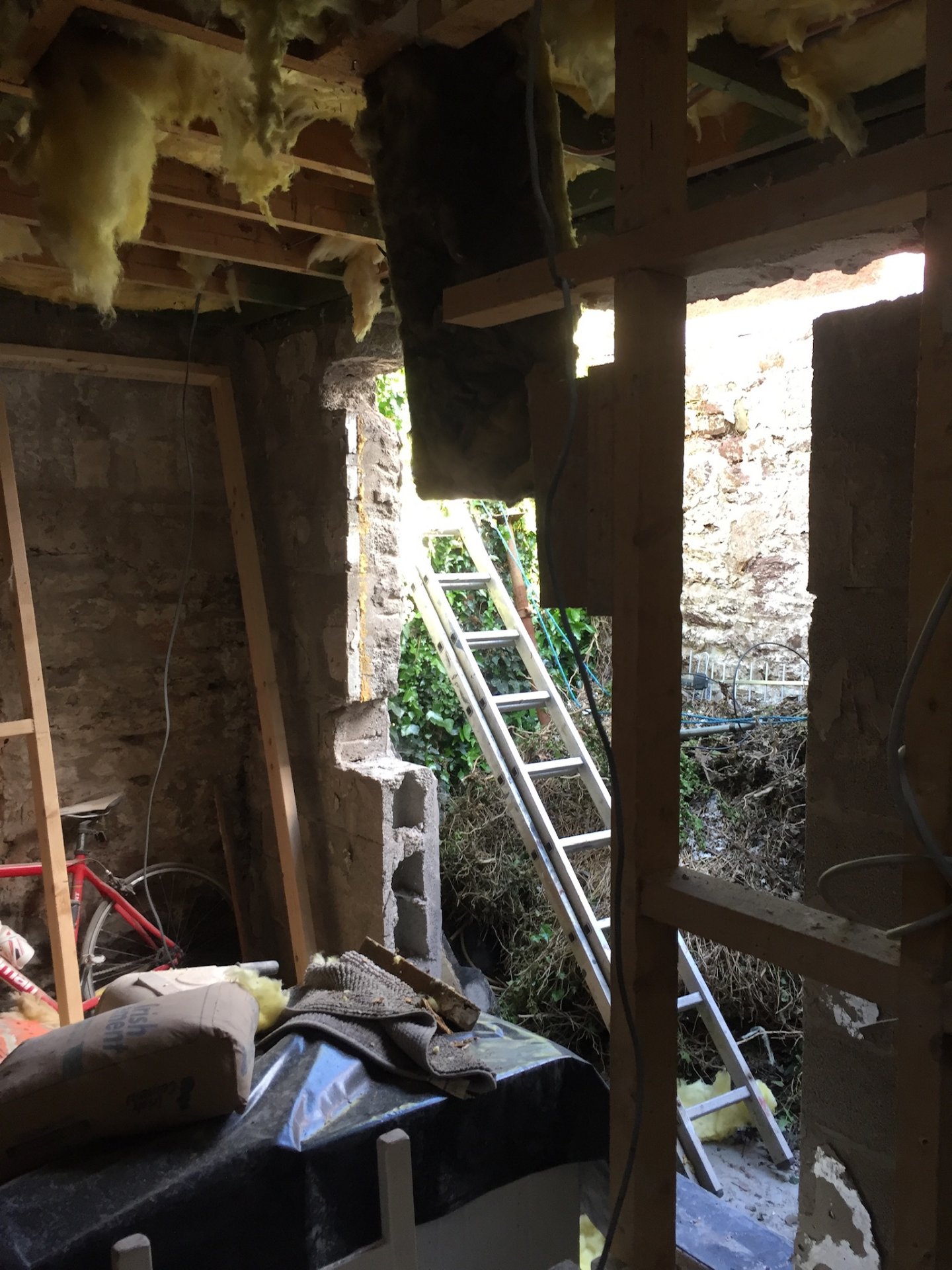 The rear of the house opened up to the courtyard during the works, walls stripped back to stone.
